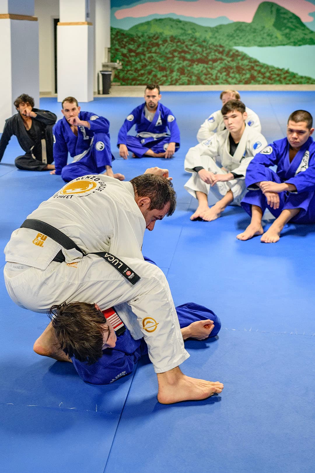 Black belt instructor demonstrating technique to a class at Renzo Gracie Jiu-Jitsu Wall Street