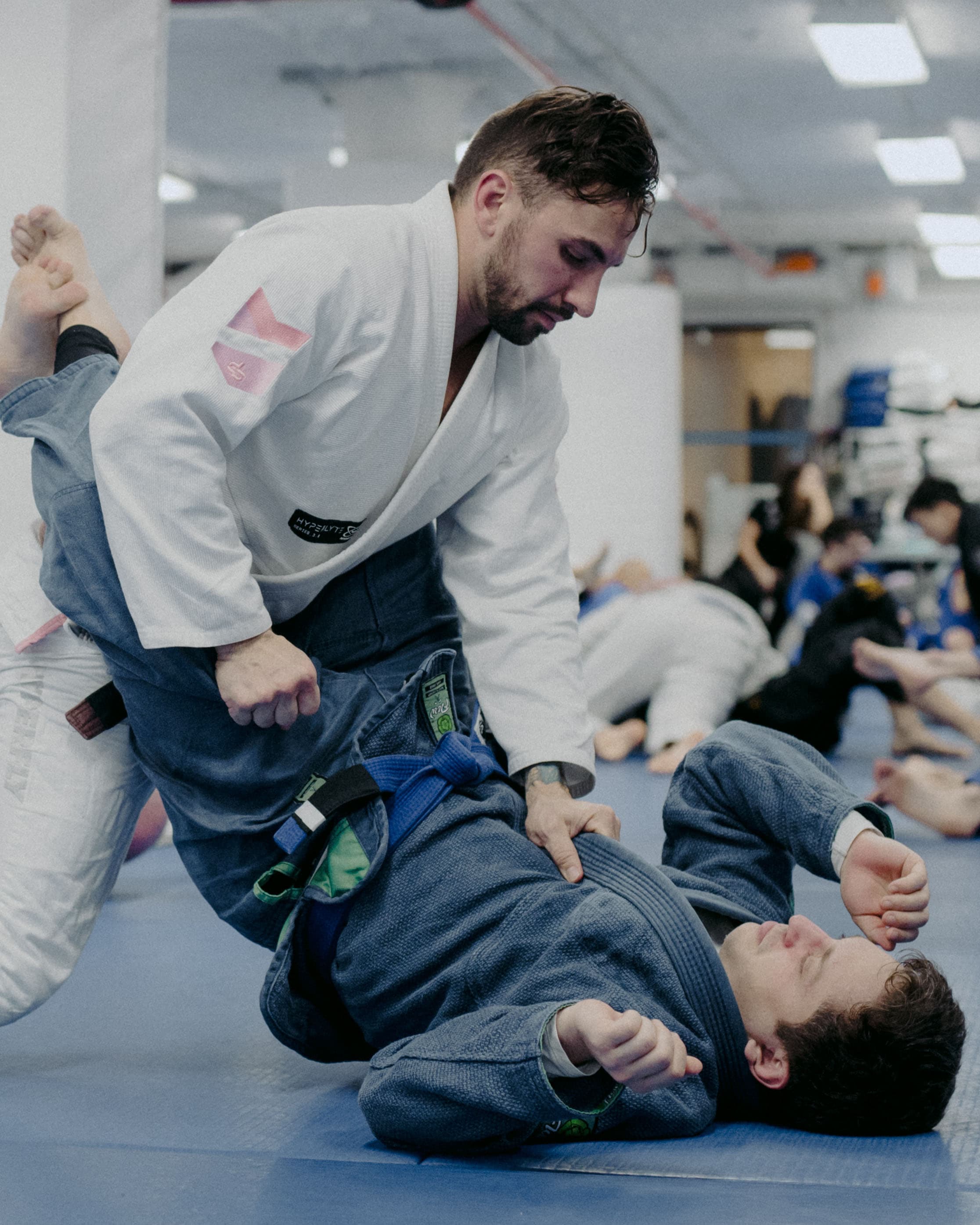Black belt instructor demonstrating technique to a class at Renzo Gracie Jiu-Jitsu Wall Street