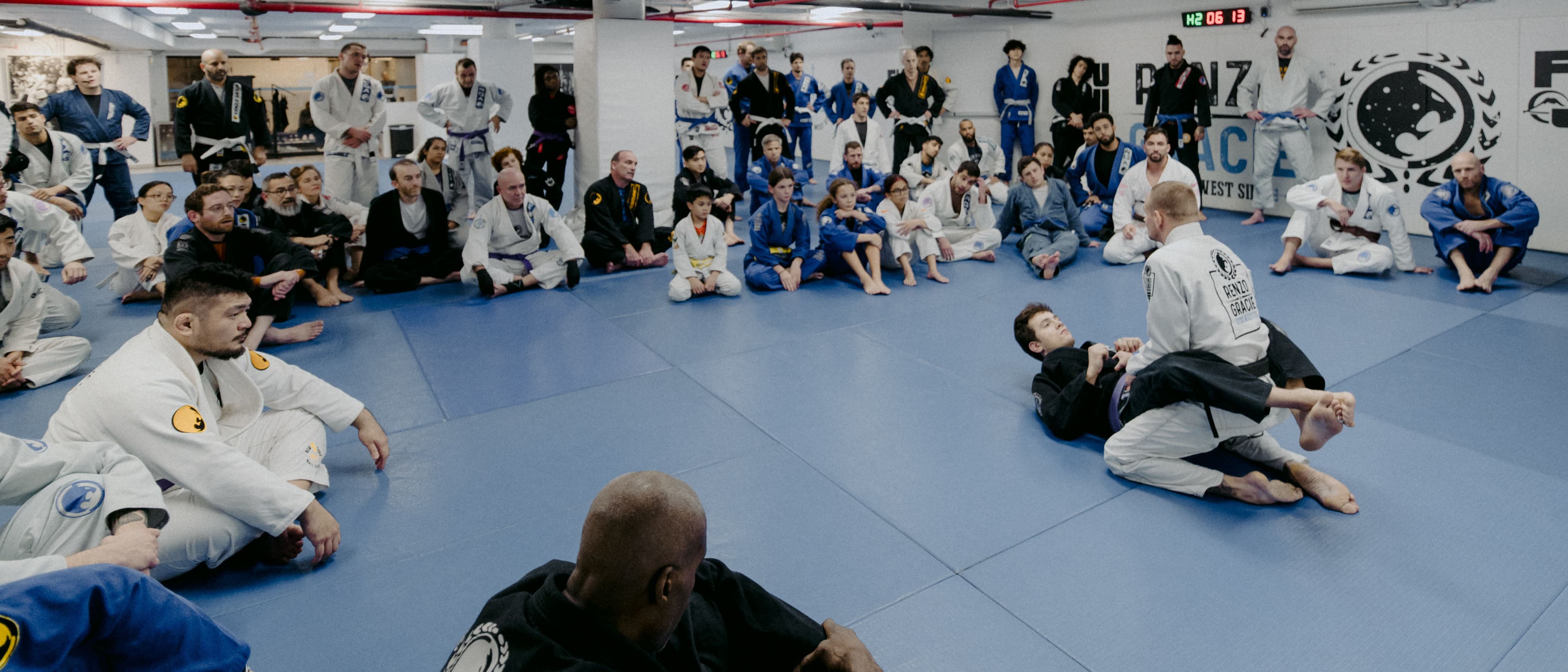 Black belt instructor demonstrating technique to a class at Renzo Gracie Jiu-Jitsu Wall Street